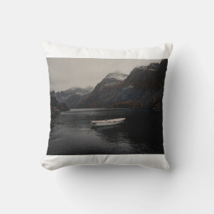 WHITE BOAT ON BODY OF WATER NEAR MOUNTAINS CUSHION