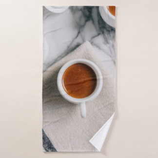 WHITE CERAMIC TEACUP FILLED WITH RED LIQUID BATH TOWEL