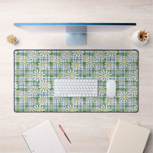 White chamomile flowers on a green blue checkered  desk mat