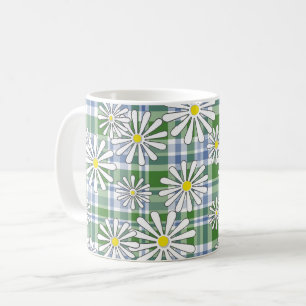 White chamomile flowers on a green blue chequered coffee mug