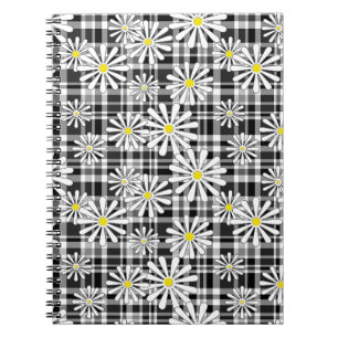 White chamomile flowers on black white chequered b notebook