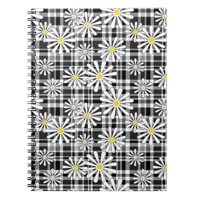 White chamomile flowers on black white chequered b notebook (Front)
