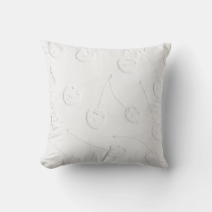 White cherrys on white fabric cushion
