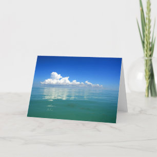 White cloud over a placid ocean card
