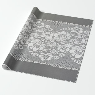 White colour straight strip of lace fabric on grey wrapping paper
