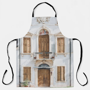 WHITE CONCRETE BUILDING WITH WOODEN DOORS AND WIND APRON