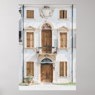 WHITE CONCRETE BUILDING WITH WOODEN DOORS AND WIND POSTER