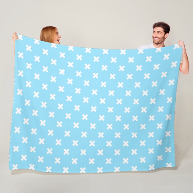 White cross stitches on baby blue fleece blanket (In Situ)