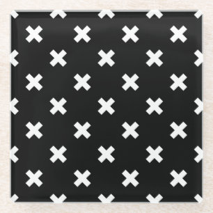 White cross stitches on black glass coaster