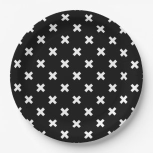 White cross stitches on black paper plate