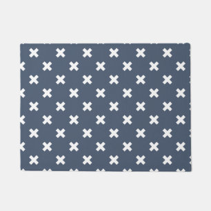 White cross stitches on blue-grey doormat