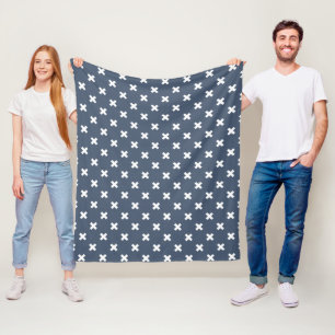 White cross stitches on blue-grey fleece blanket
