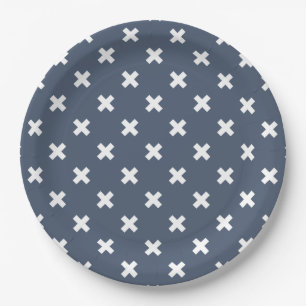 White cross stitches on blue-grey paper plate