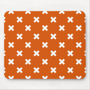 White cross stitches on burnt orange mouse pad