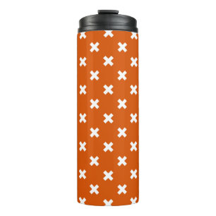 White cross stitches on burnt orange thermal tumbler