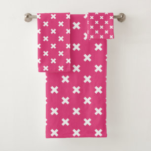 White cross stitches on fuchsia bath towel set