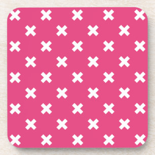White cross stitches on fuchsia coaster