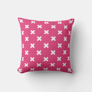 White cross stitches on fuchsia cushion