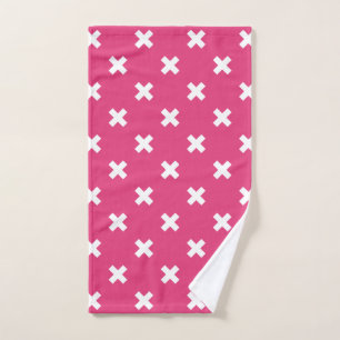 White cross stitches on fuchsia hand towel
