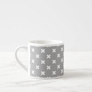 White cross stitches on grey espresso cup