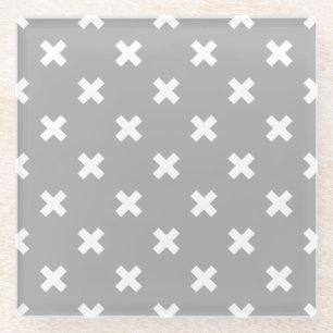 White cross stitches on grey glass coaster