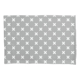 White cross stitches on grey pillowcase