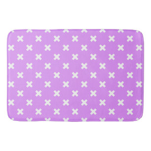 White cross stitches on lilac bath mat