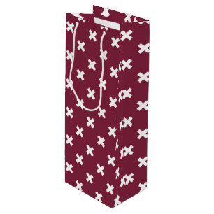 White cross stitches on mulberry wine gift bag