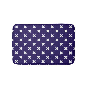 White cross stitches on navy blue bath mat