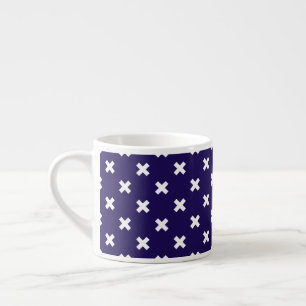 White cross stitches on navy blue espresso cup