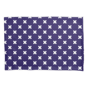White cross stitches on navy blue pillowcase