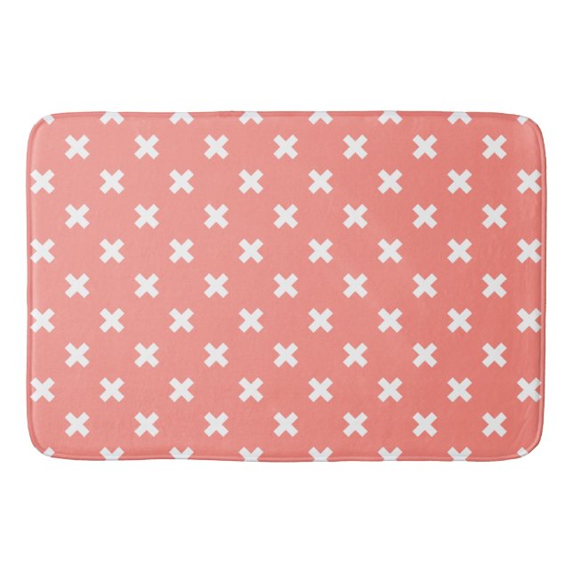 White cross stitches on peach bath mat (Front)