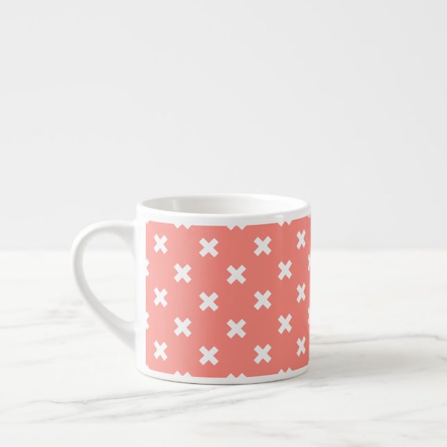 White cross stitches on peach espresso cup (Left)