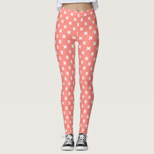 White cross stitches on peach leggings