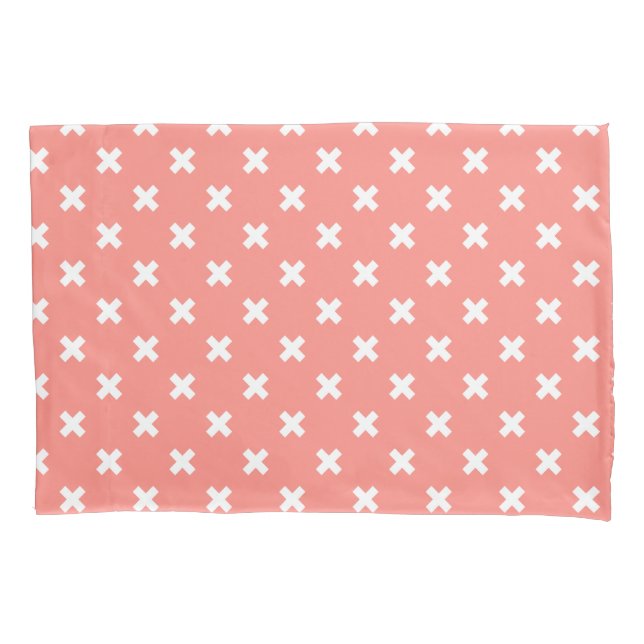 White cross stitches on peach pillowcase (Front)
