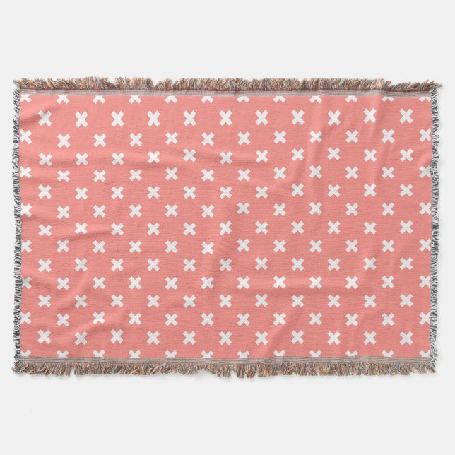 White cross stitches on peach throw blanket (Front)