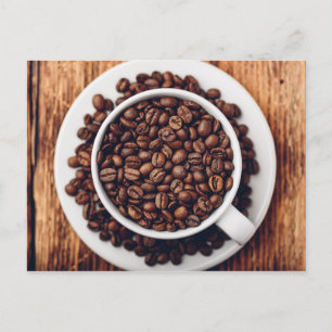 White cup full of roasted coffee beans postcard
