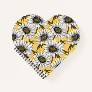 White daisies, wild flowers on yellow notebook