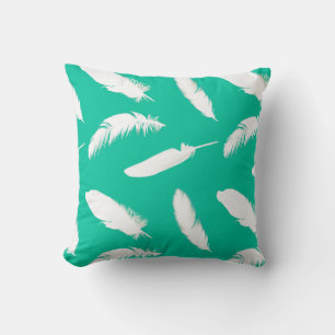 White feather print on turquoise cushion