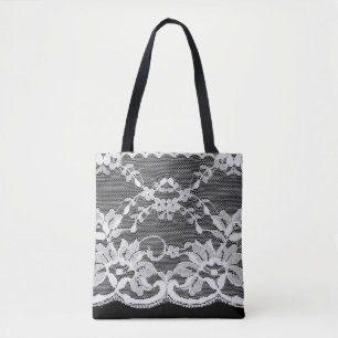 White floral lace on a black background. tote bag
