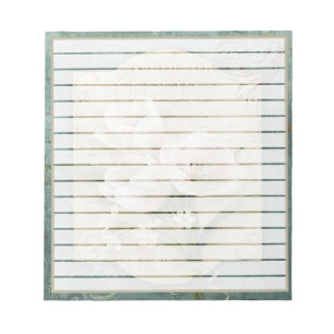 White flowers on green notepad