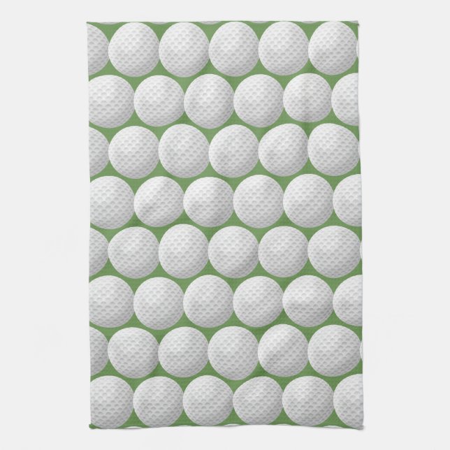 white golf balls on green tea towel (Vertical)