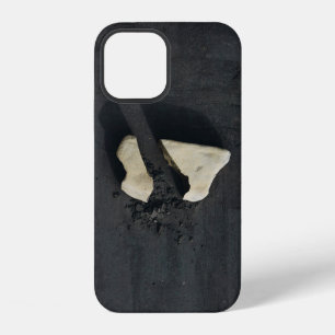 White heart shaped on black surface iPhone 12 case