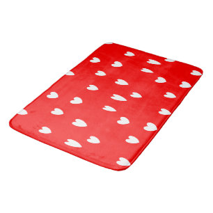 White hearts pattern on red bath mat