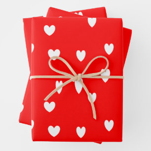 White hearts pattern on red wrapping paper sheet
