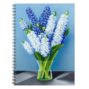 White Hyacinths in a Glass Vase on Blue Notebook