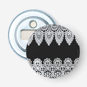 White lace forms a delicate border against black bottle opener