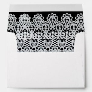 White lace forms a delicate border against black envelope