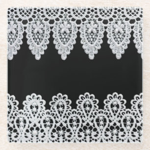 White lace forms a delicate border against black glass coaster