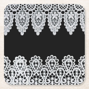 White lace forms a delicate border against black square paper coaster